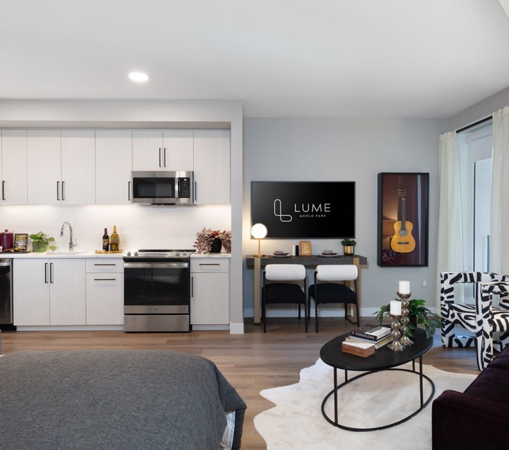 Refined spaces to match your style living room with chairs and view of a kitchen